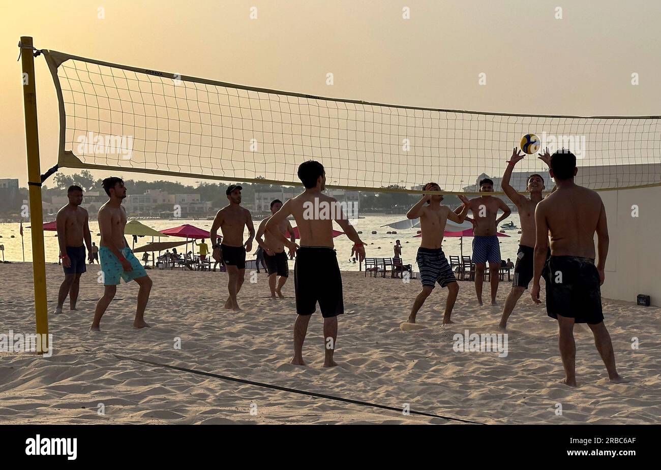 Doha, Qatar. 7th July, 2023. Young people play volleyball on Katara