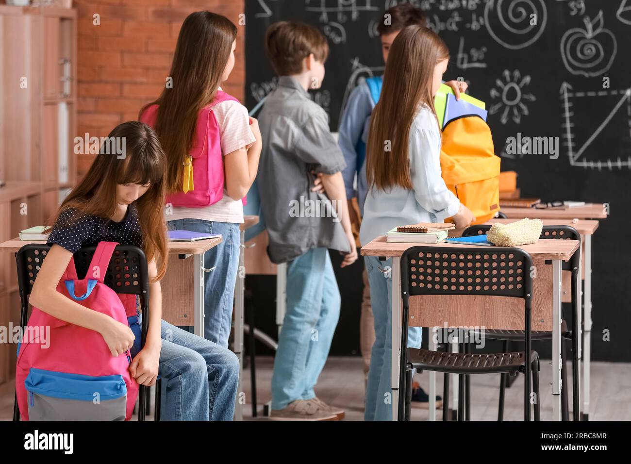 Little pupils with backpacks in classroom Stock Photo Alamy