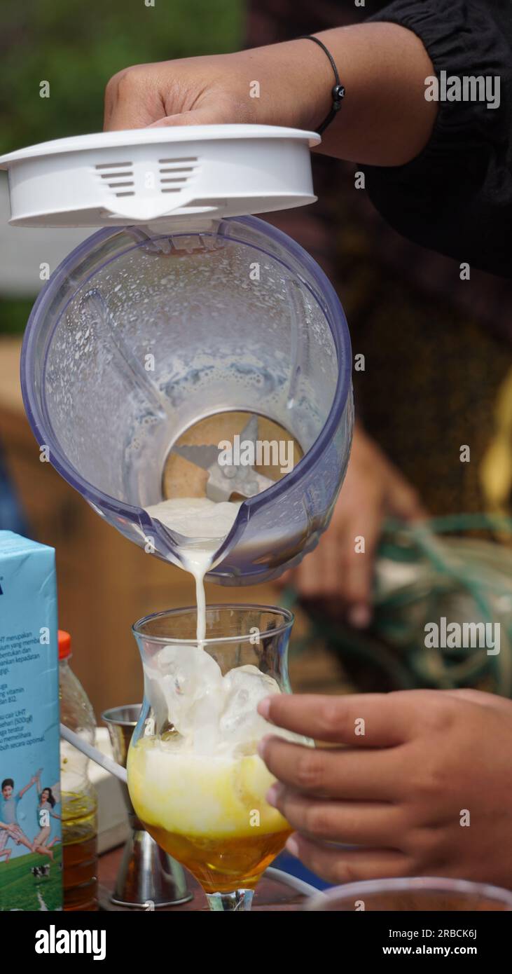 The barista is serving coffee with liquid for customer Stock Photo Alamy