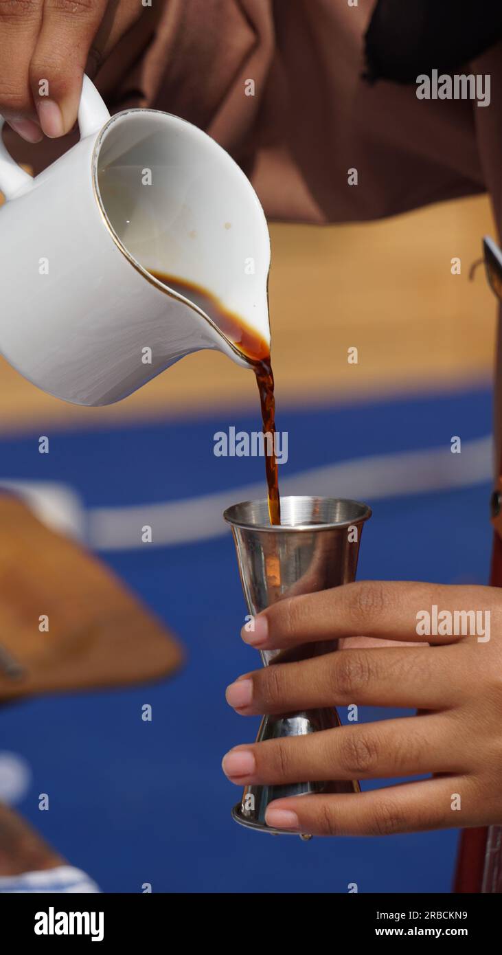 The barista is serving coffee with liquid for customer Stock Photo Alamy