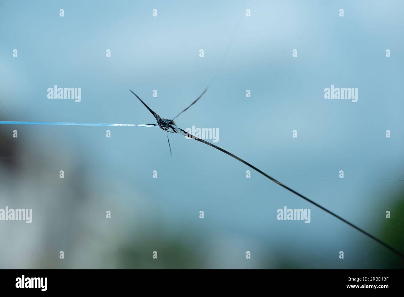 Cracked windshield from the stone thrown. View from inside the car. Stock Photo
