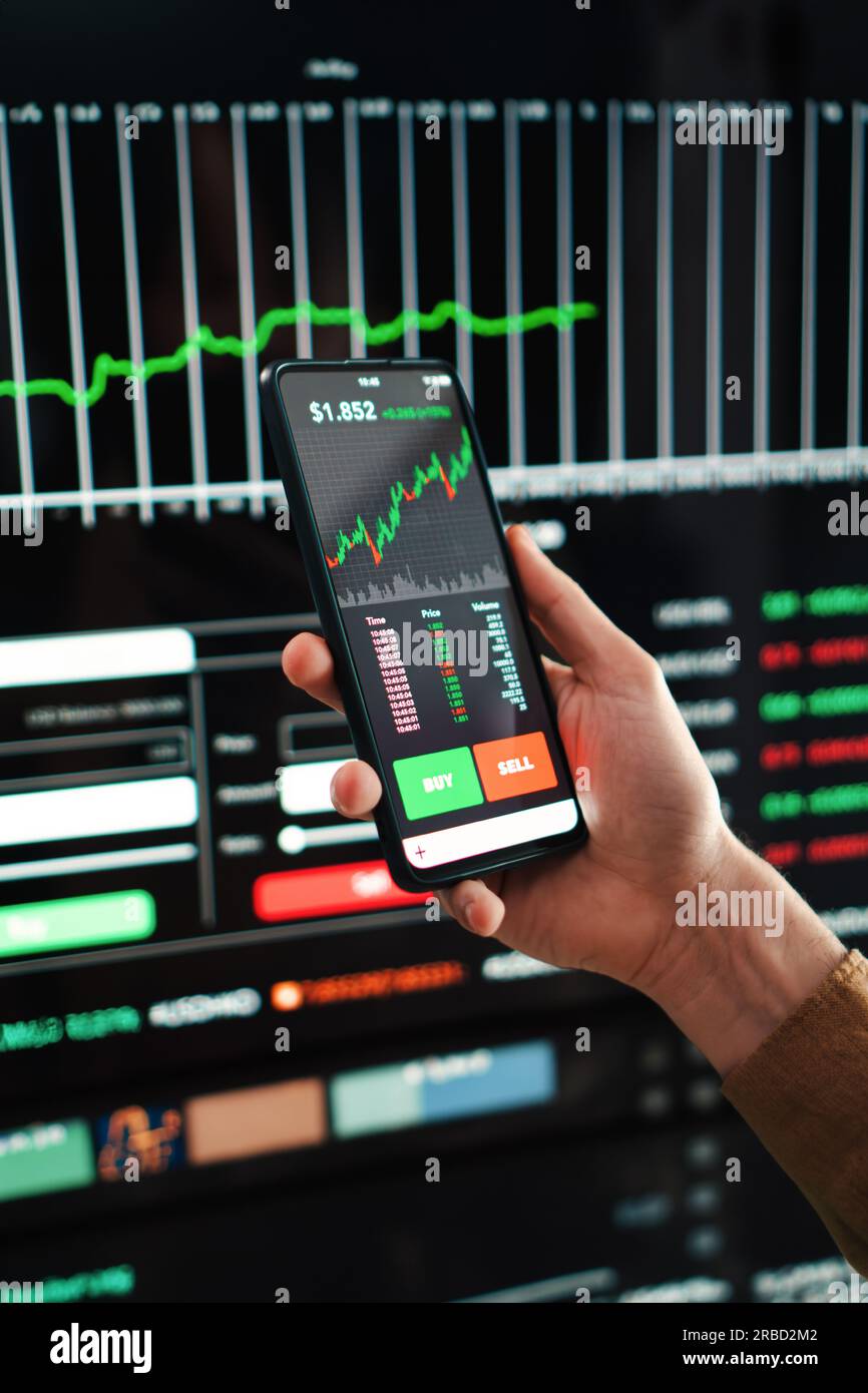 Vertical portrait of crypto trader broker using a cell phone financial app  to buy or sell shares of stock market. Investment concept. Hand holding a  smartphone with banking blockchain application. High quality