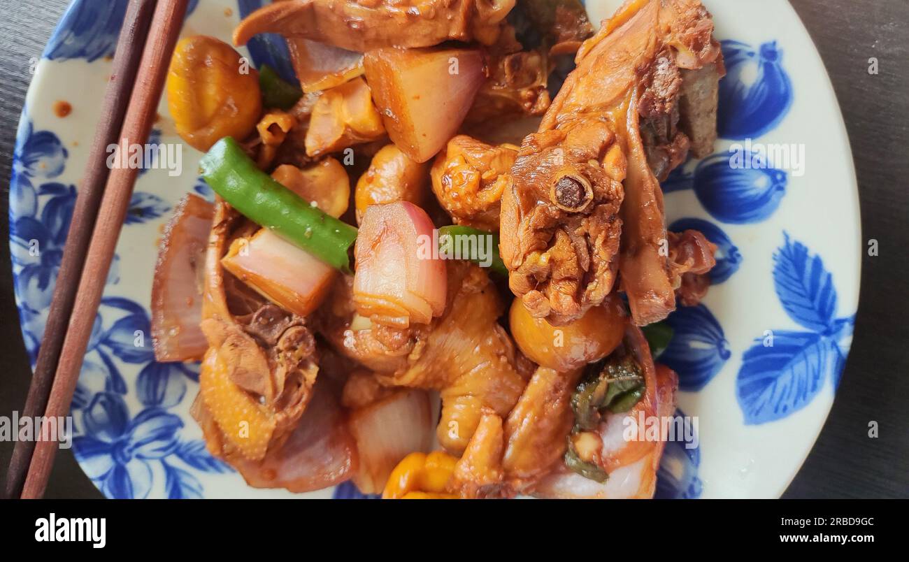 fresh braised chicken with green peppers on the white plate for eating Stock Photo