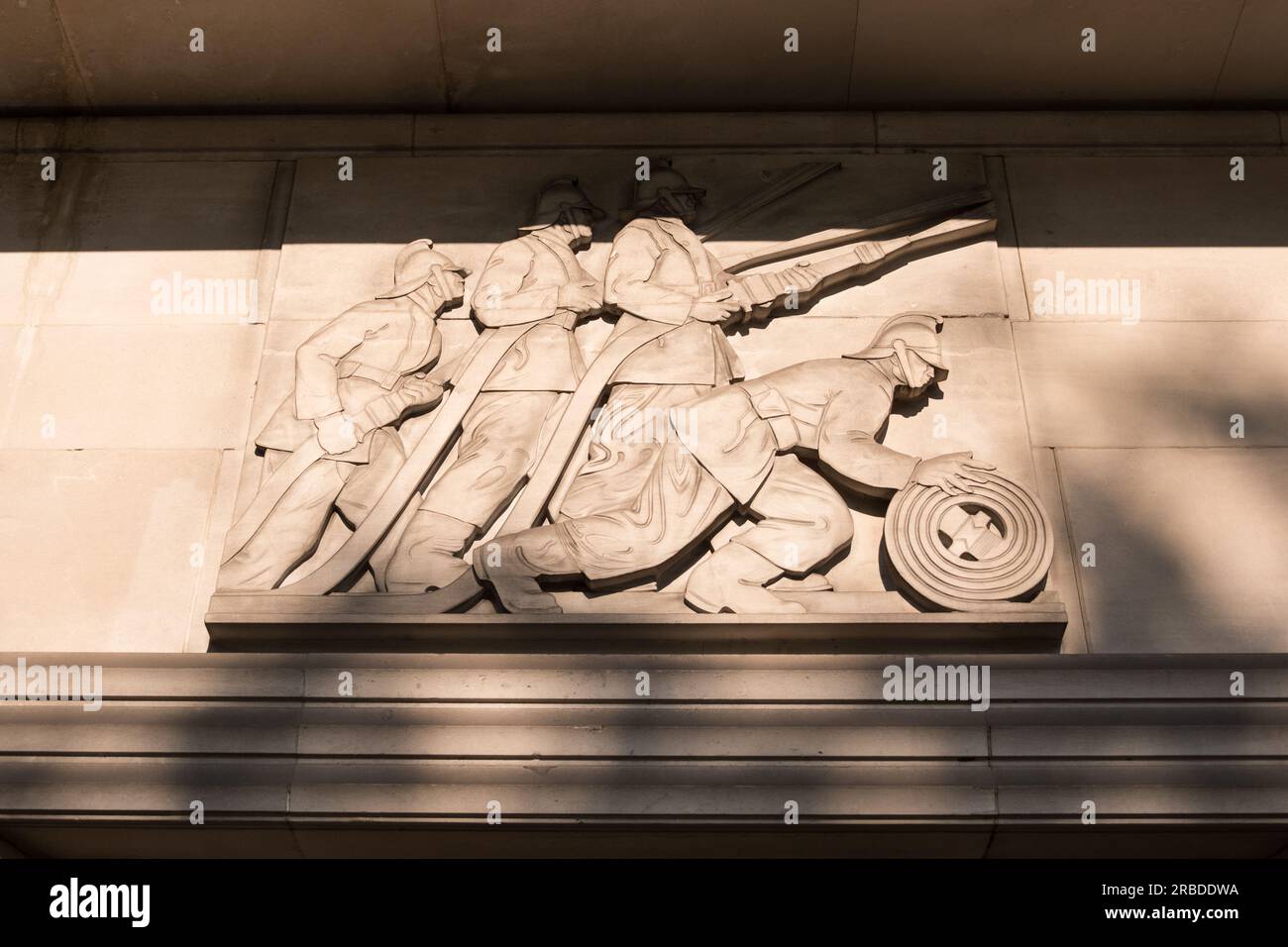 A carved relief by Gilbert Bayes on the former headquarters of London Fire Brigade, Lambeth Fire Station, Albert Embankment, Lambeth, London, U.K. Stock Photo