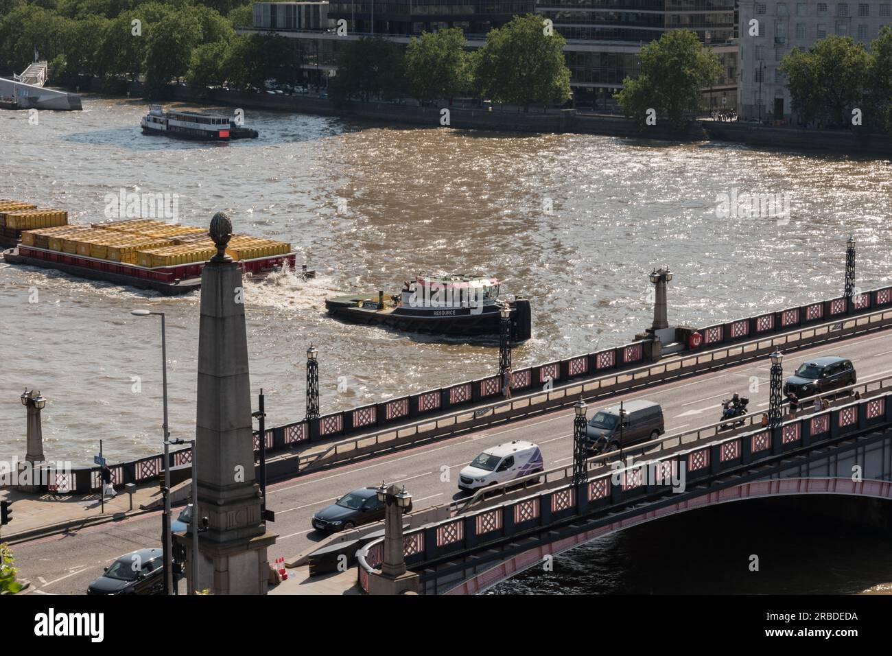 Resource, a Cory tug boat transporting industrial waste downstream under Lambeth Bridge on the River Thames, London, England, U.K. Stock Photo