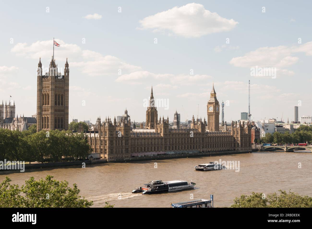 Uber Boats passing the Houses of Parliament and Big Ben on the River Thames, London, England, U.K. Stock Photo