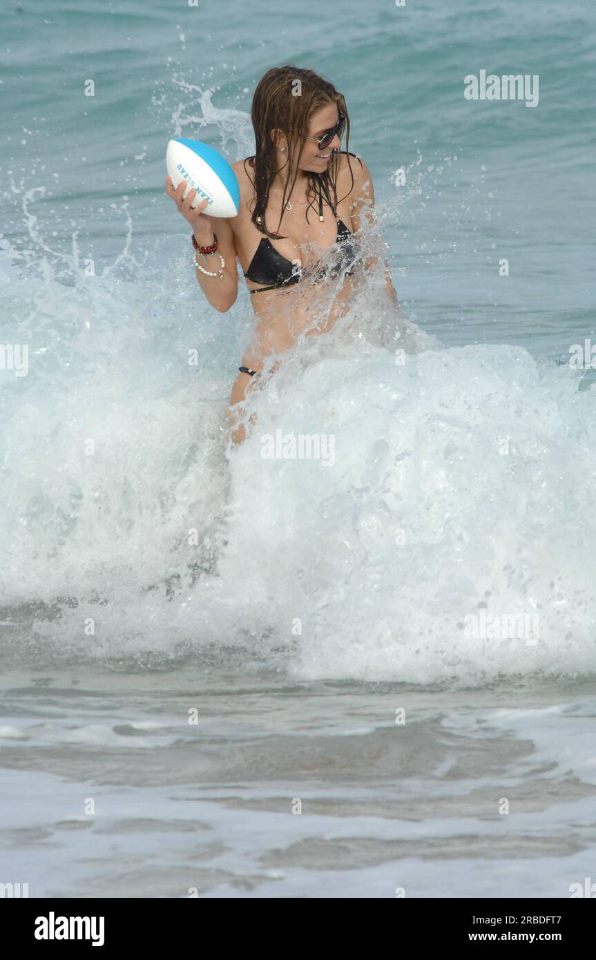 MIAMI BEACH, FL - DECEMBER 31: Maria Menounos looks amazing in a tiny black bikini but has a major wardrobe malfunction as her bikini bottoms slide showing her neatly trimmed private parts as she plays football in the ocean.  Maria Menounos (born June 8, 1978) is a Greek-American actress, journalist, and television presenter known in America for her appearances as a correspondent for Today and Access Hollywood, and abroad for co-hosting the Eurovision Song Contest 2006 in Athens, Greece.  On December 31, 2010 in Hollywood, Florida   People:  Maria Menounos Stock Photo