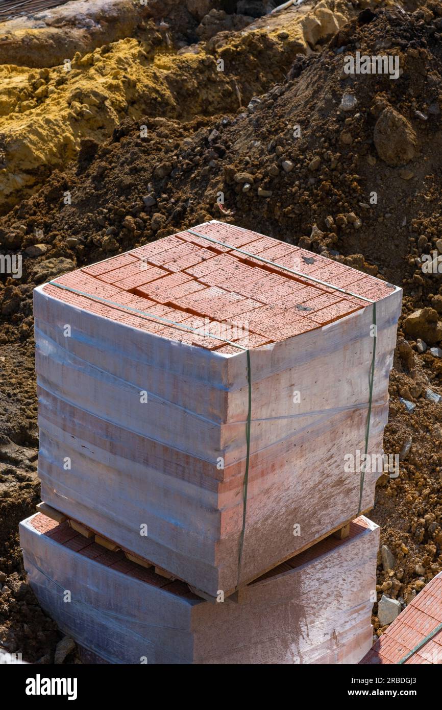 pallets and packages of red bricks in a construction warehouse on the ...