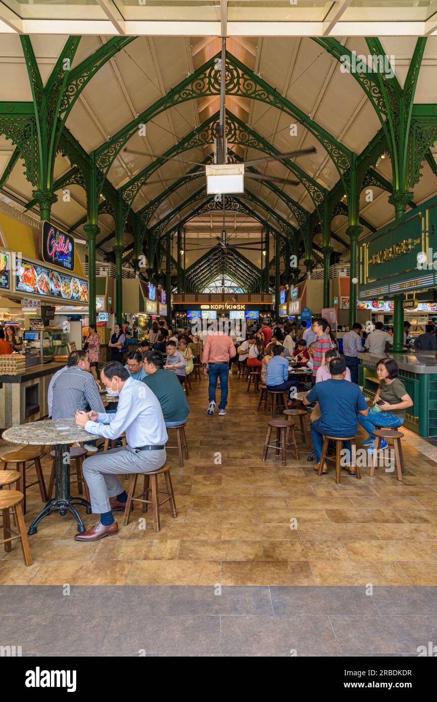 Busy tables of Singaporeans eating lunch at Lau Pa Sat hawker centre, Singapore Stock Photo