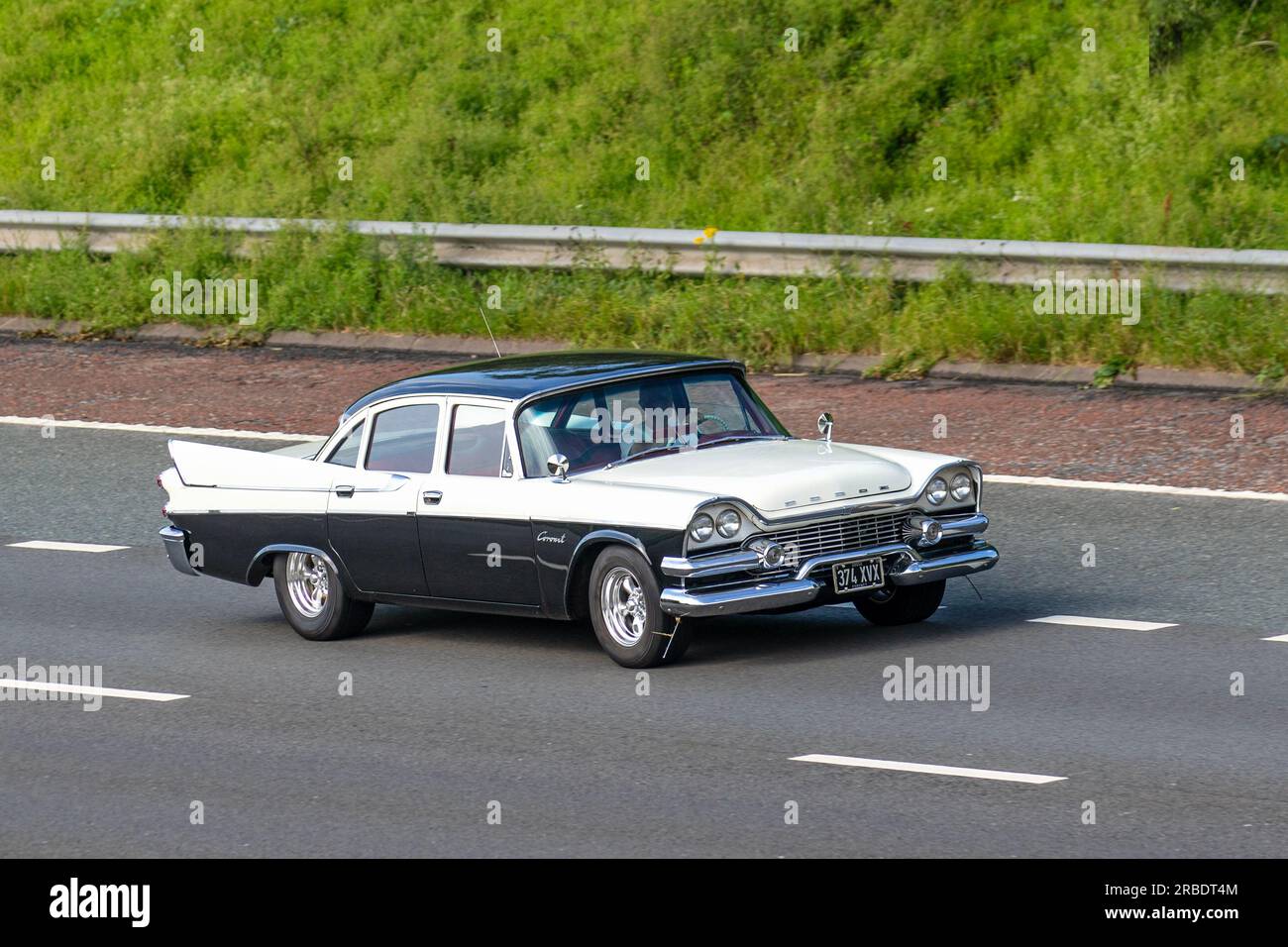 1958 50s fifties Black White Dodge (usa) sedan; travelling at speed on the M6 motorway in Greater Manchester, UK Stock Photo
