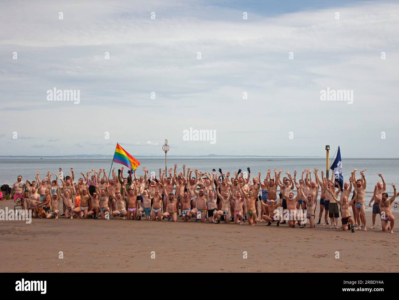 Portobello, Edinburgh, Scotland, UK. 09 July 2023, temperature 20 degrees for those taking exercise on the sandy beach and in the Firth of Forth. Pictured: Edinburgh Blueballs and friends with their annual Porty Pride dip on the final day the Portobello Pride weekend. Credit: Scottishcreative/alamy live news. Stock Photo