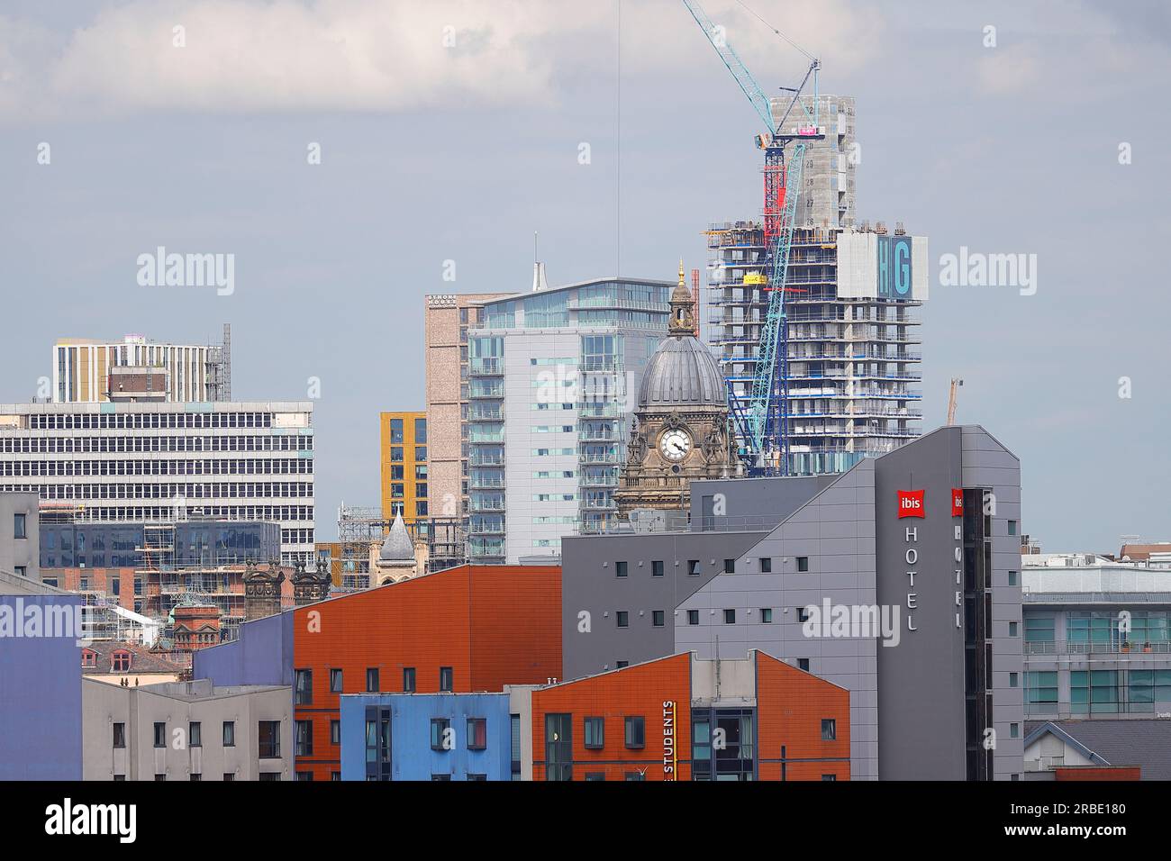Leeds City Centre showing Leeds Town Hall Clock Tower and the construction of a new tall