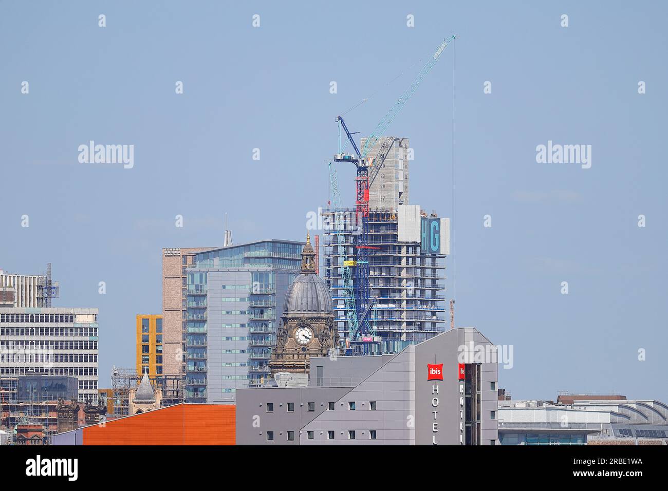 Leeds City Centre showing Leeds Town Hall Clock Tower and the construction of a new tall