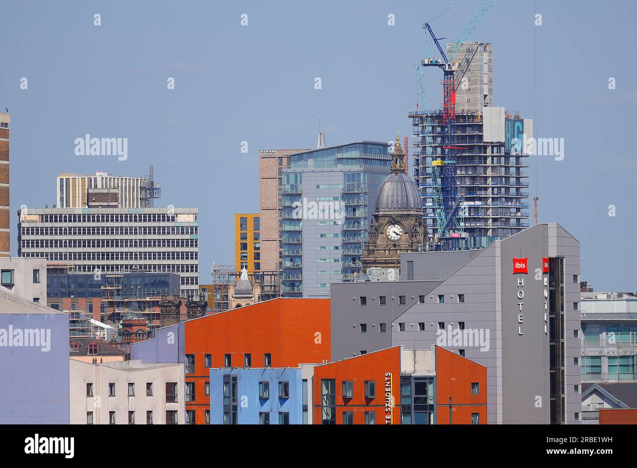 Leeds City Centre showing Leeds Town Hall Clock Tower and the construction of a new tall