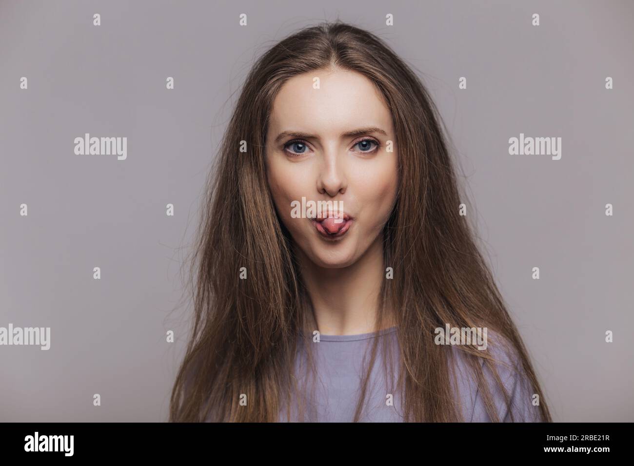 Funny female, attractive look. Playfully sticks out tongue