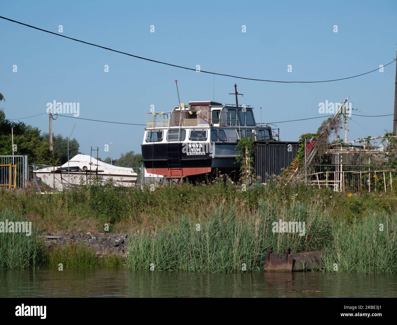 Kruibeke, Belgium, 08 July 2023, The boat Nova VVW Kruibeke is on dry land along the side of the river Scheldt Stock Photo