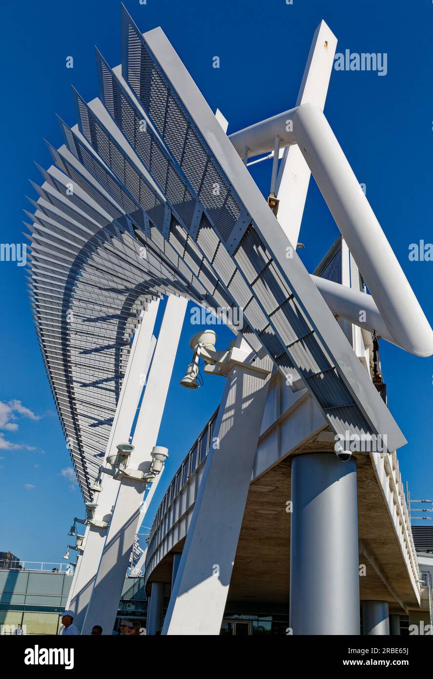 Brilliant white against a blue sky, a steelpanel arch soars above the