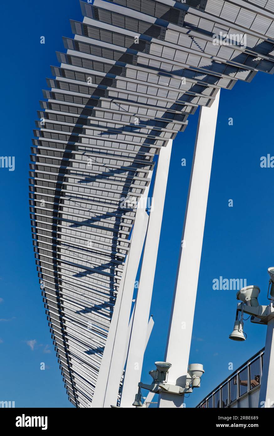 Brilliant white against a blue sky, a steelpanel arch soars above the