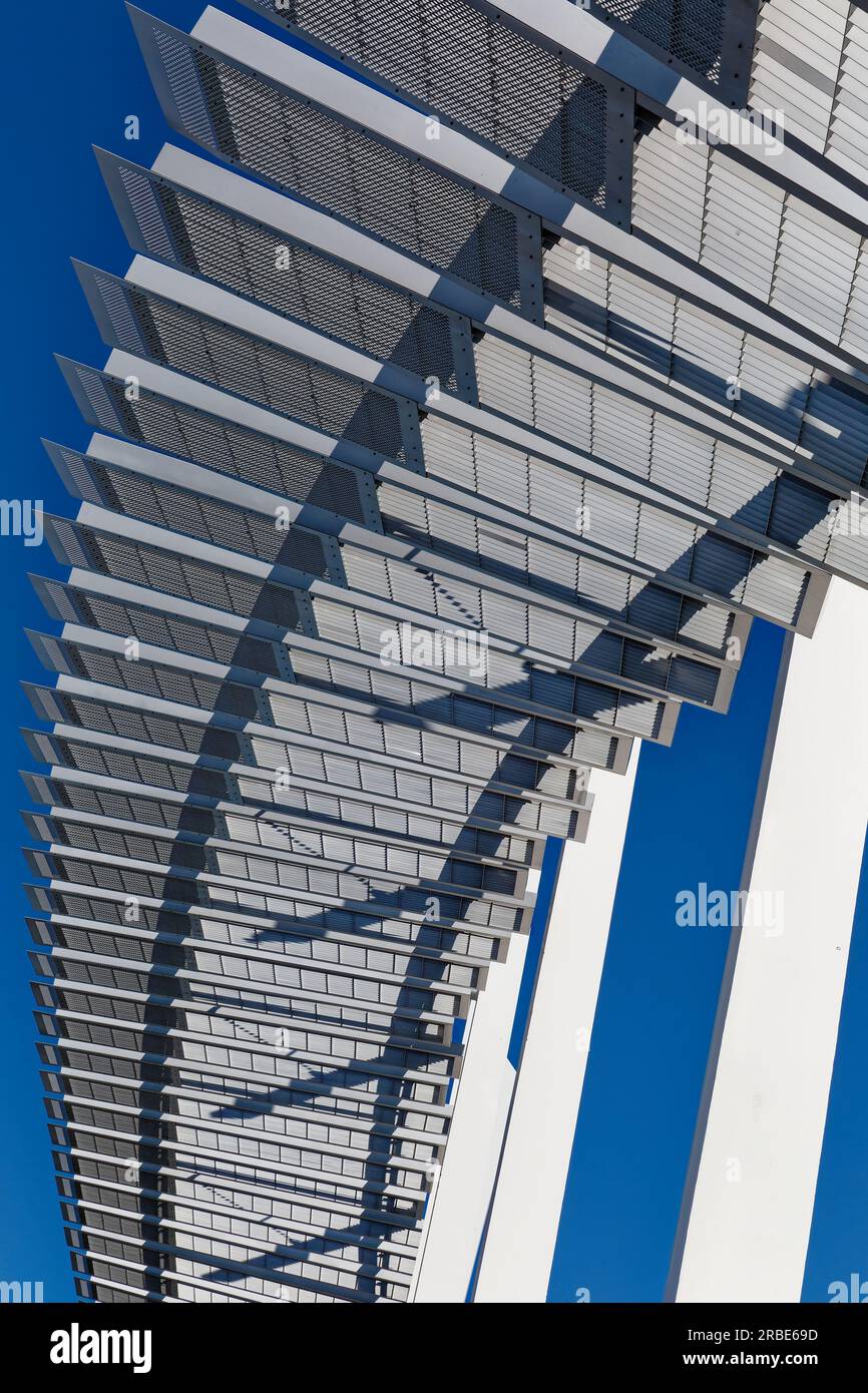 Brilliant white against a blue sky, a steelpanel arch soars above the