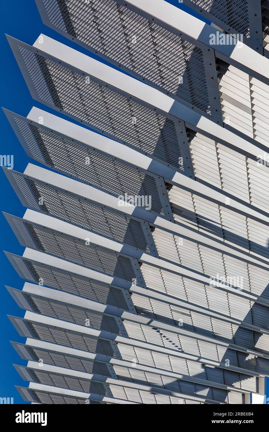 Brilliant white against a blue sky, a steelpanel arch soars above the