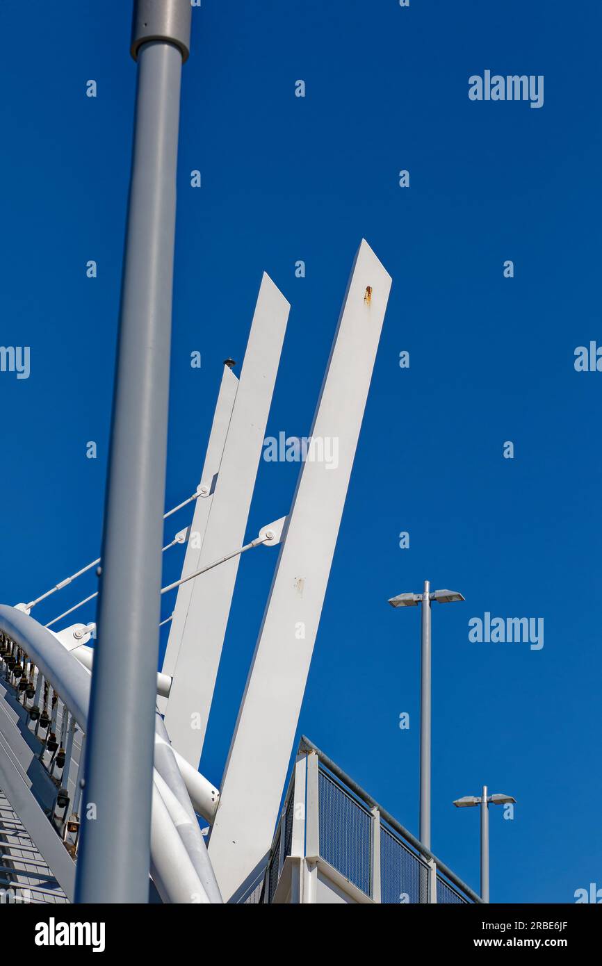 Brilliant white against a blue sky, a steelpanel arch soars above the