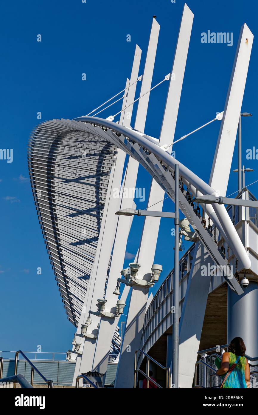 Brilliant white against a blue sky, a steelpanel arch soars above the