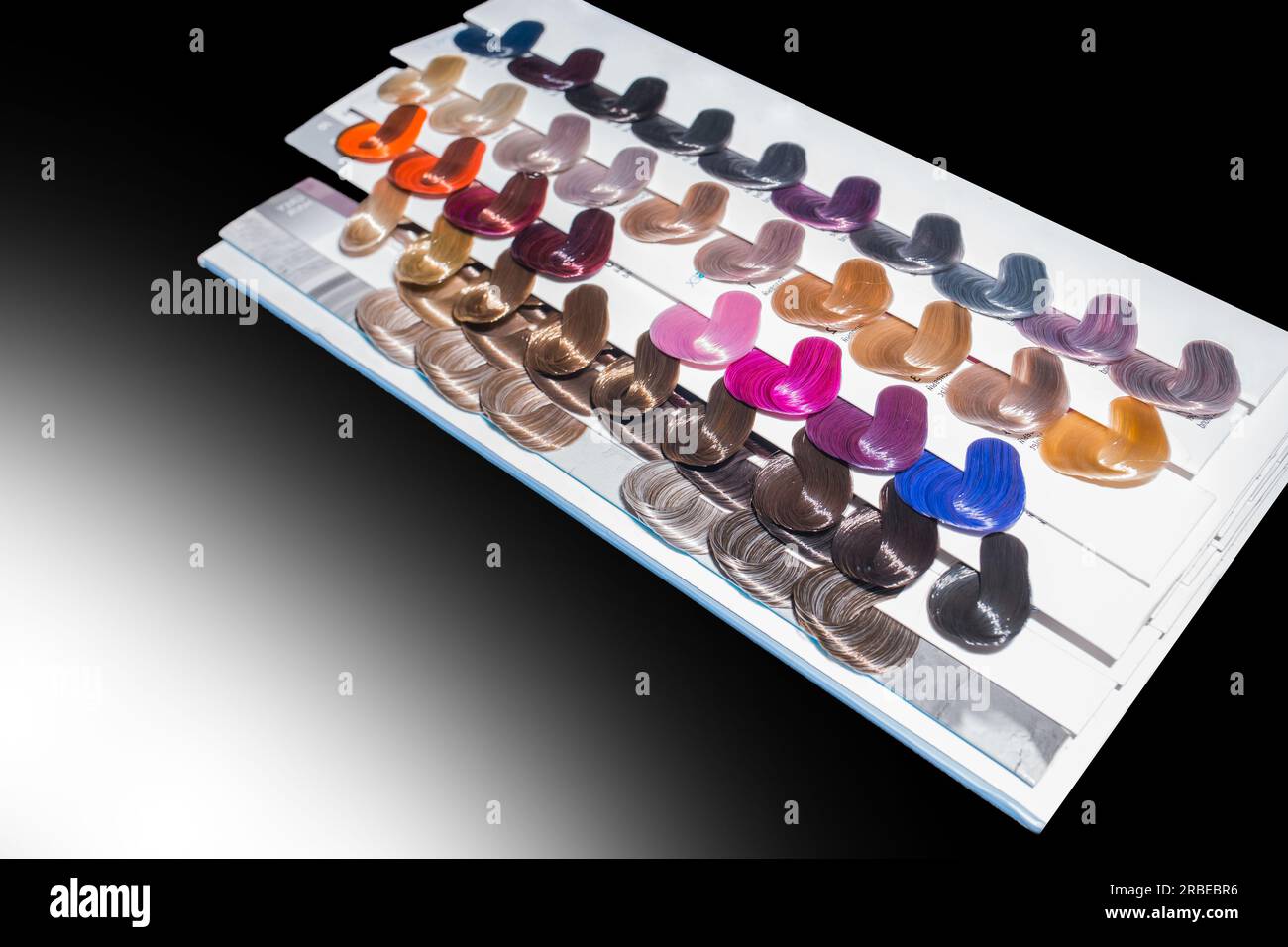 Miscellaneous various samples color palette dye coloring hair shade tint on black and white background isolated. Stock Photo
