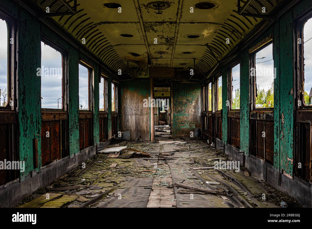 Interior of old messy passenger carriage with windows during daylight Stock Photo