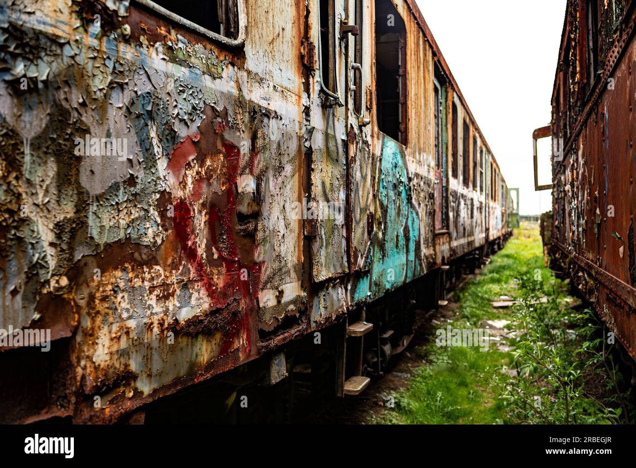 Perpective shot of old damaged trains and wagons, vintage background very shallow depth of field Stock Photo