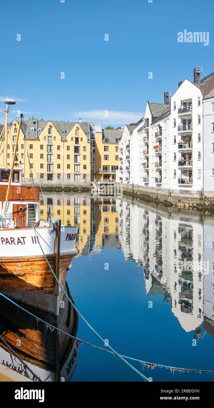 Tranquil morning scene with the famous art nouveau buildings reflecting in the pristine waters of the narrow canal crossing through the town centre Stock Photo