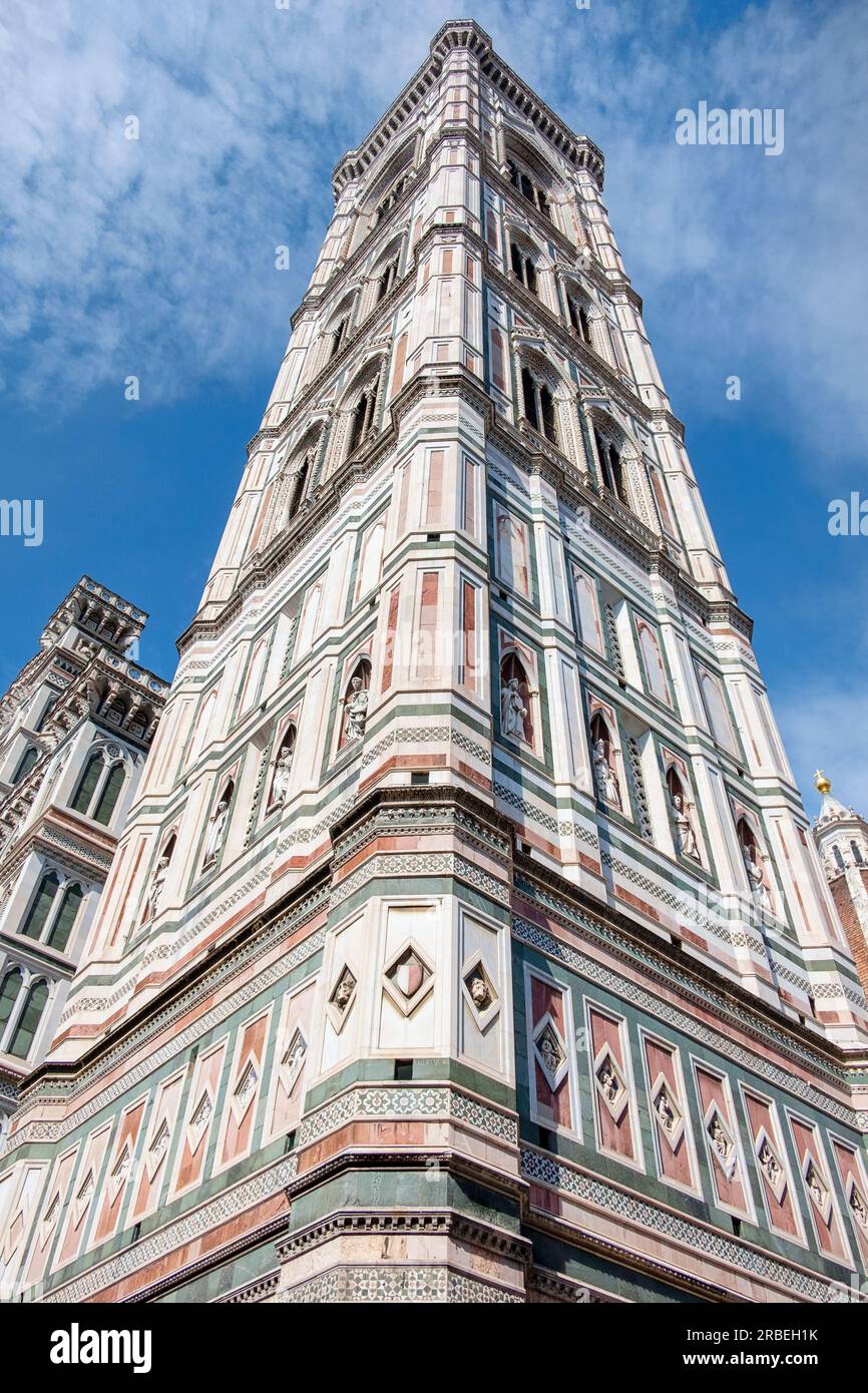 Looking up at the fabulous Campanile di Giotto bell tower made of white, green and red marble, of the iconic Italian Cathedral, Santa Maria del Fiore Stock Photo