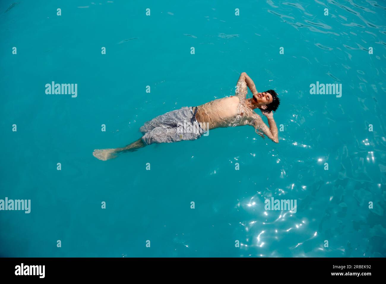 Sanaa. 9th July, 2023. A teenager plays at a public pool during a heatwave in Sanaa, Yemen on July 9, 2023. Credit: Mohammed Mohammed/Xinhua/Alamy Live News Stock Photo