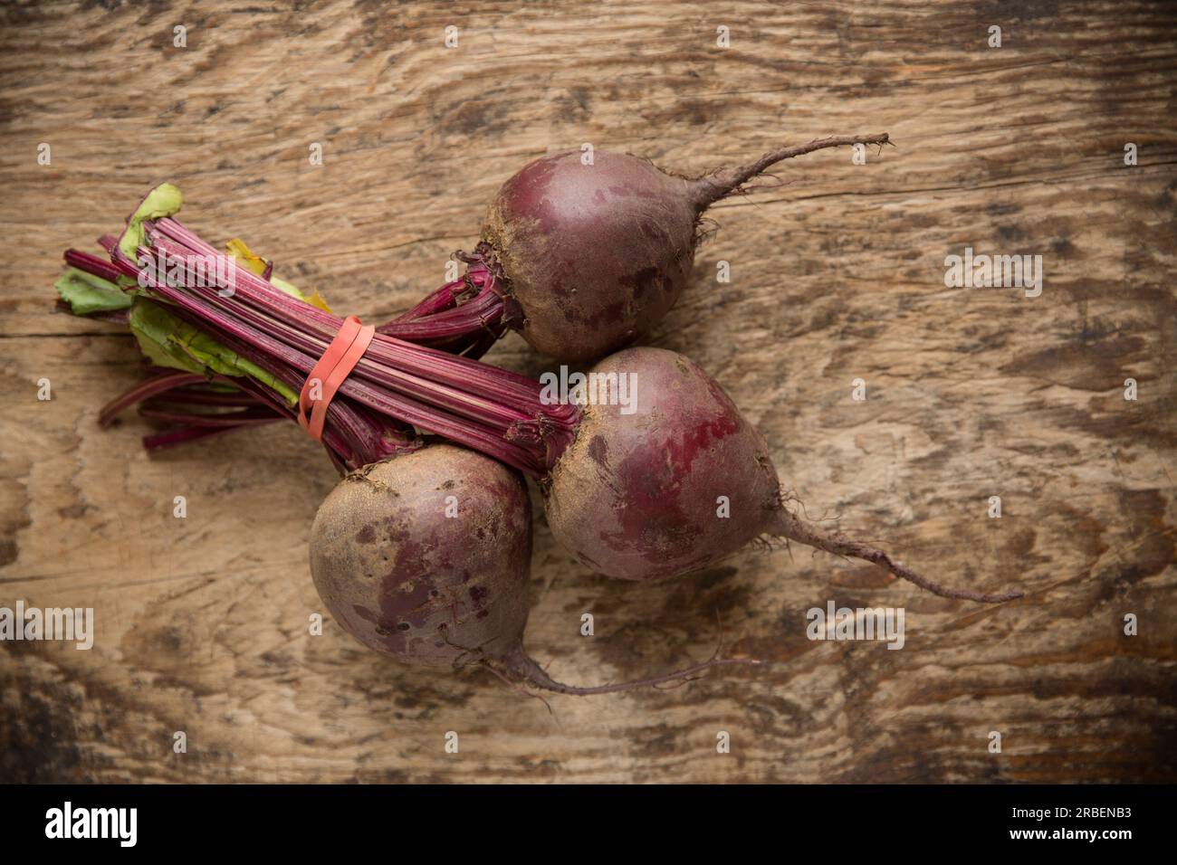 Three whole raw beetroot from a supermarket in the UK that will be used to make Borscht soup. England UK GB Stock Photo