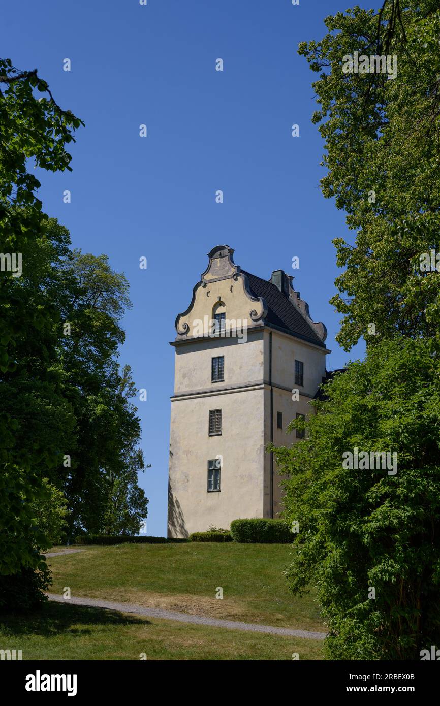 fragment of the castle, tower of the old castle in Europe. Old garden, park. Stock Photo