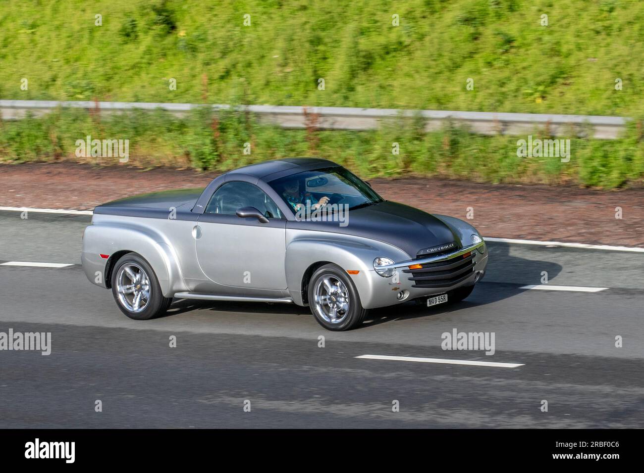 2005 Silver Chevrolet SSR Petrol 5998 cc, (Super Sport Roadster) a retro-styled retractable hardtop convertible pickup truck manufactured by Chevrolet; travelling at speed on the M6 motorway in Greater Manchester, UK Stock Photo