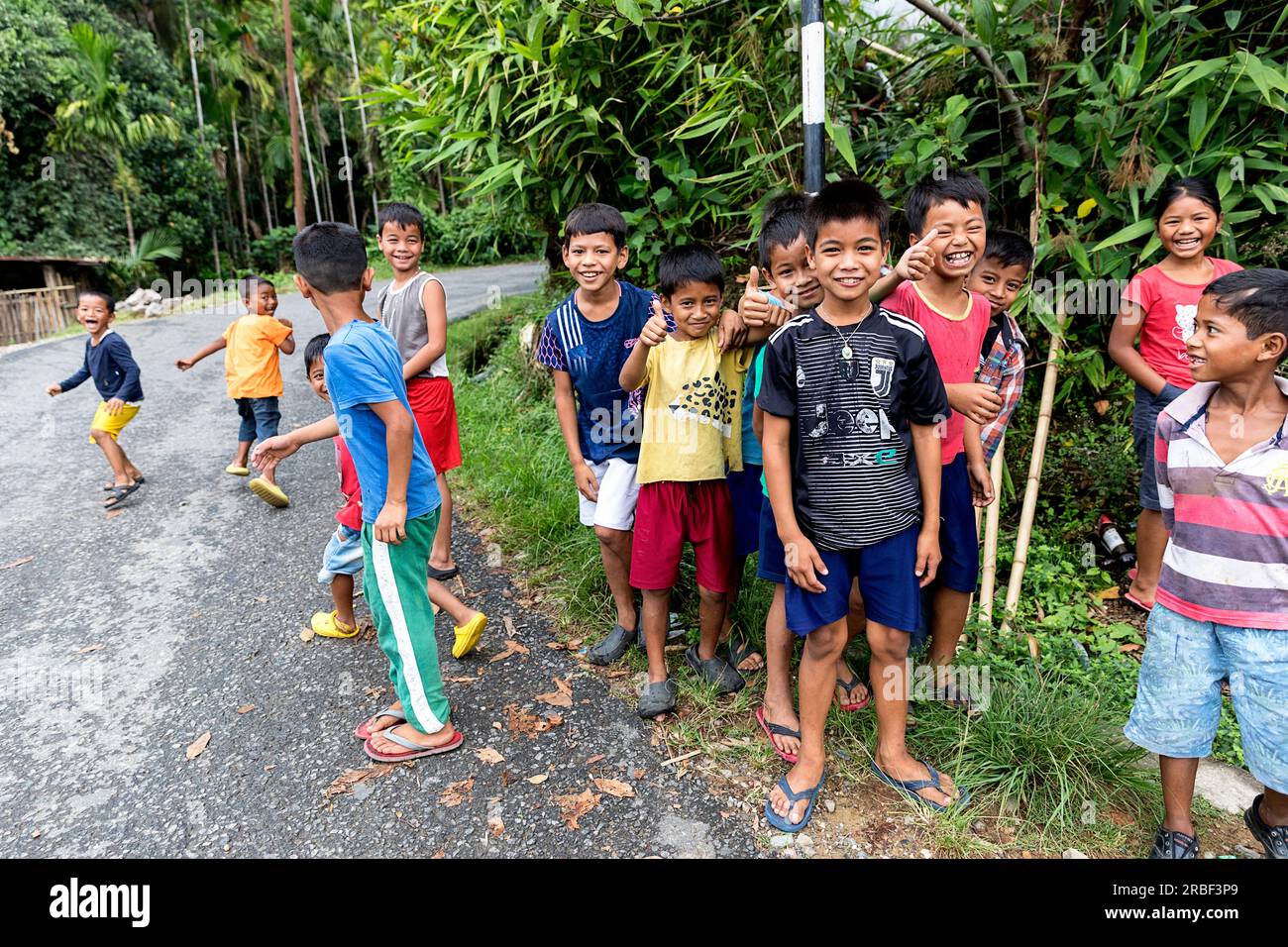Group of playful small kids by the road in remote village of India near Mawlynnong, north east India Stock Photo