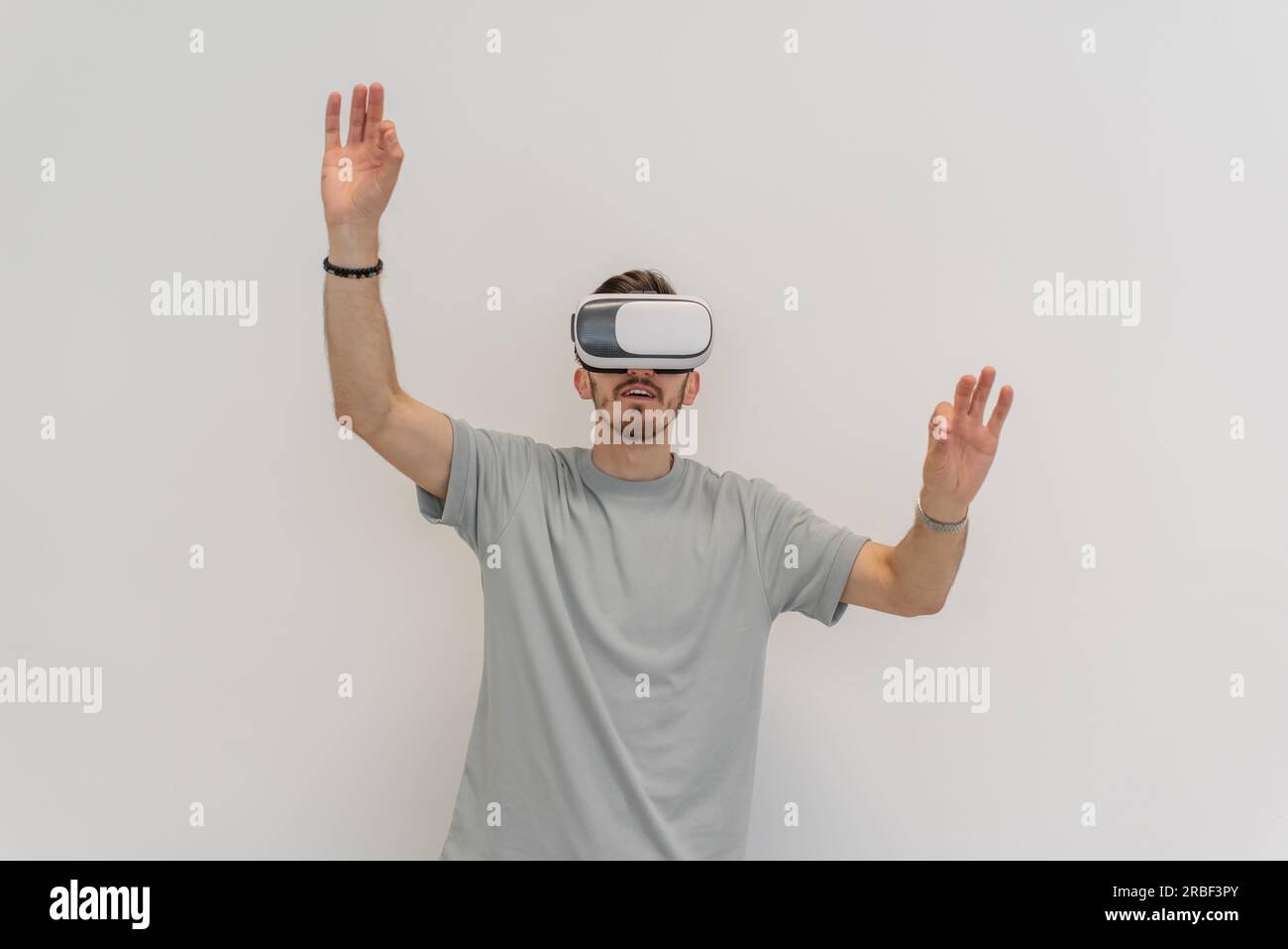 Futuristic man wearing virtual reality glasses interacts with the air ...