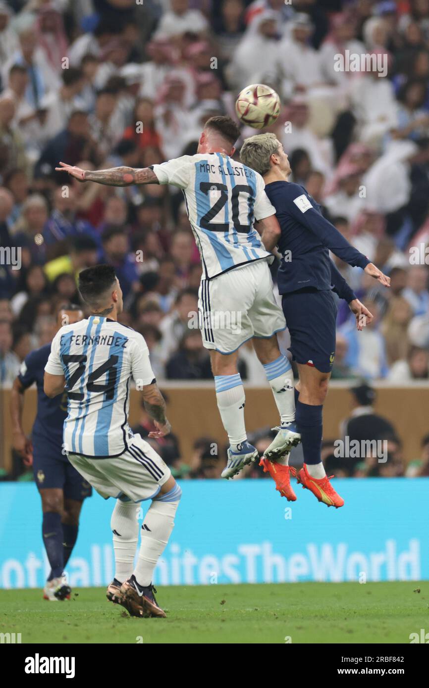 Lusail, Qatar, 18th. December 2022. Alexis Mac Allister and Antoine Griezmann dispute the ball during the match between Argentina vs. France, Match 64 Stock Photo