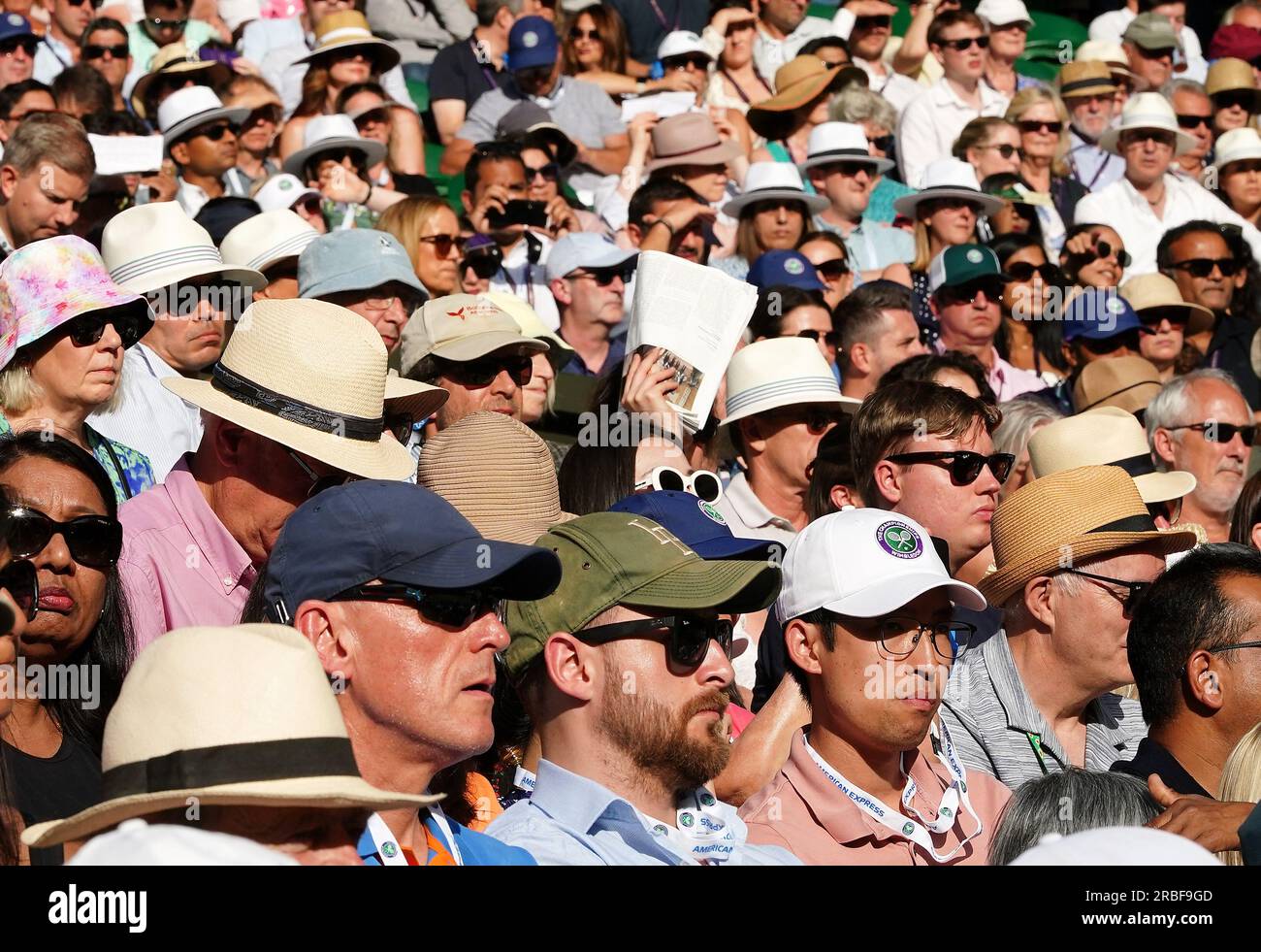 Spectators wearing hats in the sun on centre court on day seven of the 2023 Wimbledon