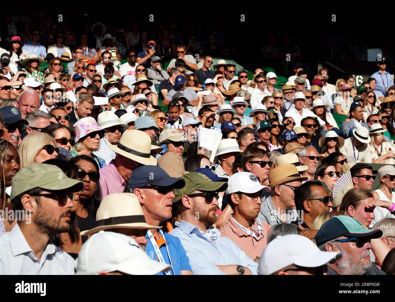 Spectators wearing hats in the sun on centre court on day seven of the 2023 Wimbledon