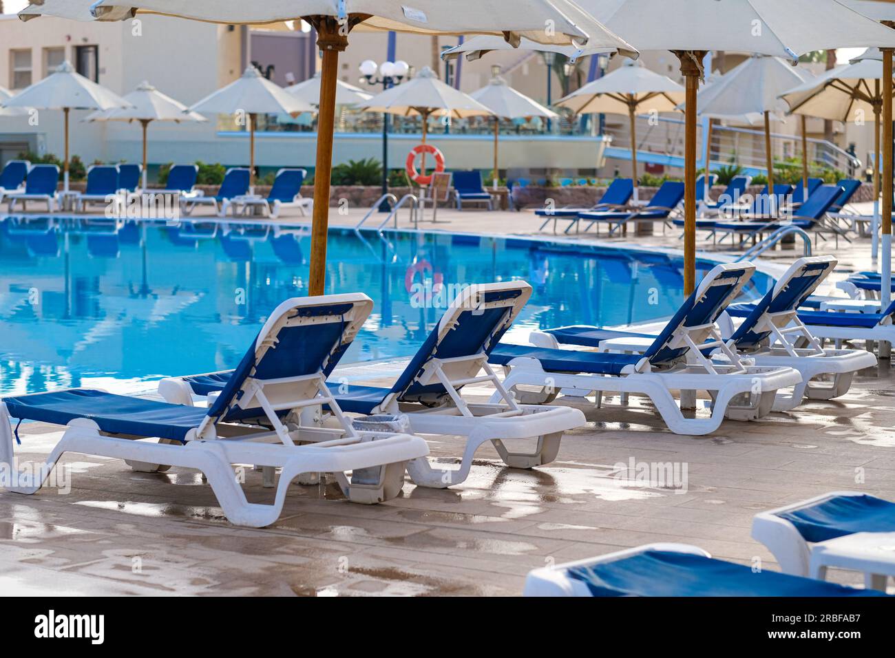 Sunbeds near swimming pool at luxury resort Stock Photo Alamy