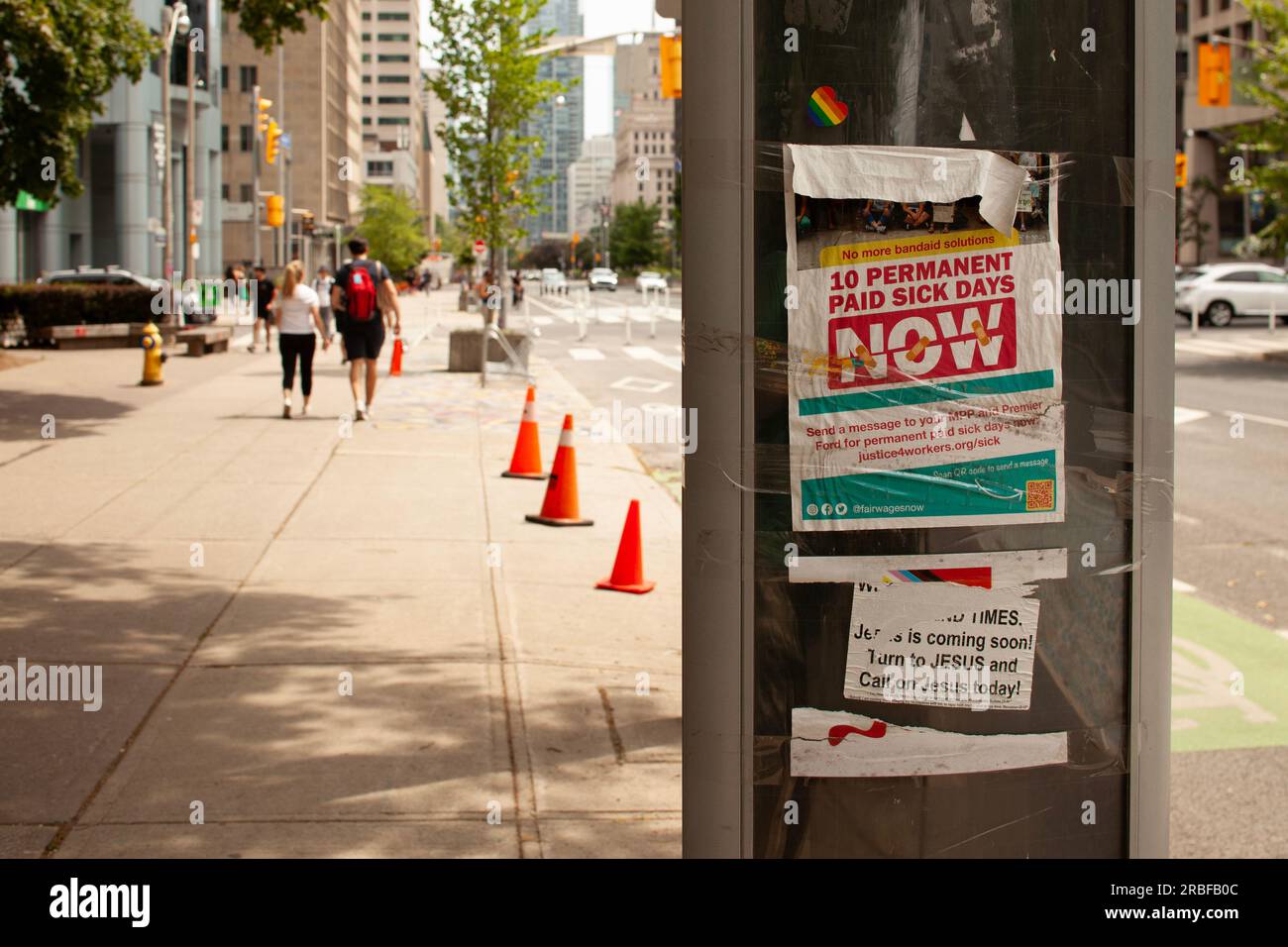 a poster in city downtown demanding 10 permanent paid sick     and calling on the government to enact meaningful legislation Stock Photo
