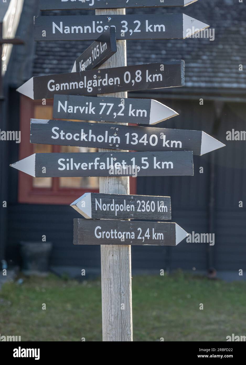 signpost Abisko Sweden Arctic Circle indicates distance and direction to various towns and sites of interest like Northpole and Stockholm Stock Photo
