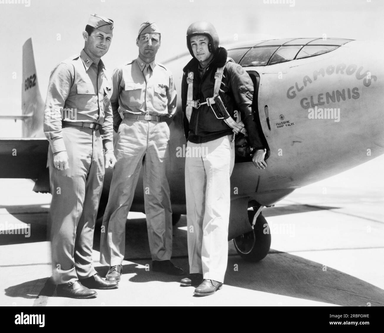 Muroc Army Air Force Base, California:  c. 1947 Standing left to right alongside of the Bell XS-1 rocket research airplane, 'Glamorous Glennis' are: Captain Charles E. Yeager, Major Gus Lundquist and Captain James Fitzgerald, wearing a flight suit. 'Glamorous Glennis' was named after Yeager's wife. Stock Photo