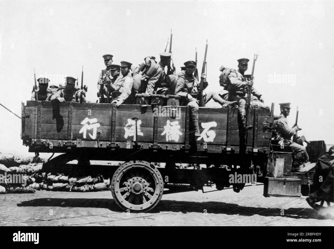 Nanking, China:  c. 1933. An army truck laden with Japanese soldiers awaits orders after the national Chinese government announced that they would not negotiate directly with Japan, Instead, the Chinese people called for a general mobilzation against Japan, and flags flew at half staff over most of China in observance of 'Humiliation Day'. Stock Photo