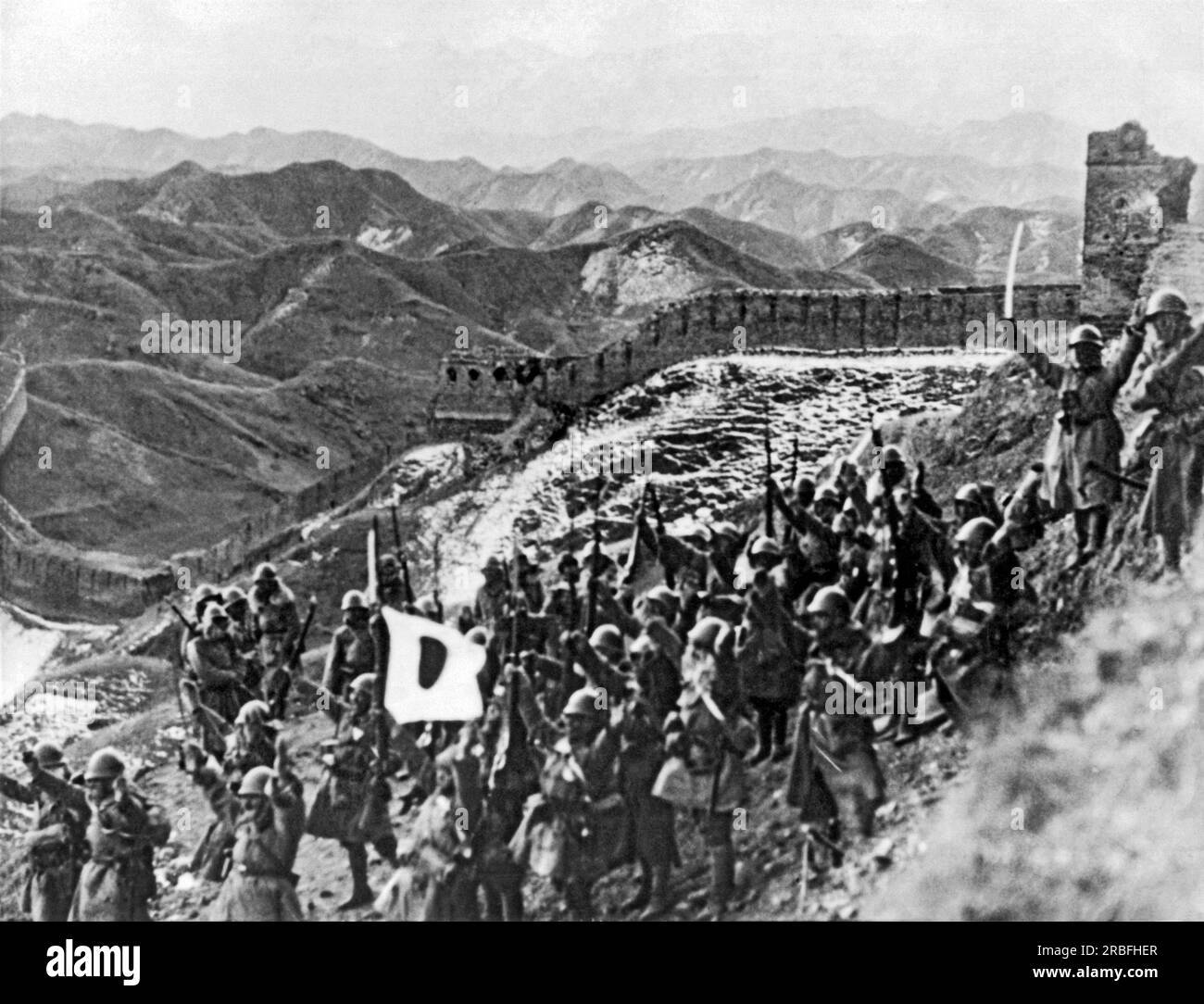 China c. 1933. Invading Japanese troops cheer as they march by the