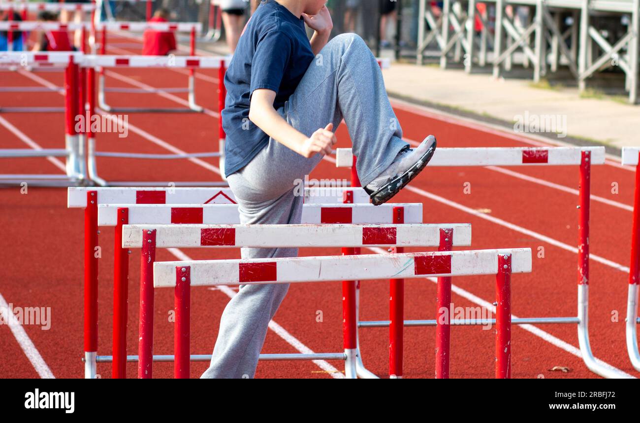 One high school girl performing hurdle warm up sports drills sideways