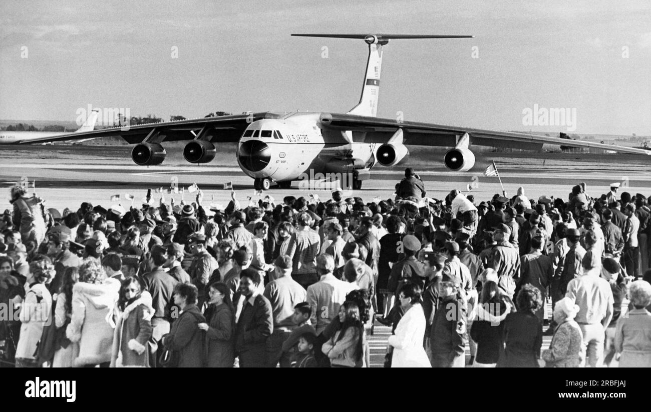 Fairfield, California:  February 14, 1973 The crowd at Travis Air Force Base waving flags as a U.S. Air Force plane arrives carrying Vietnam War POWs. Stock Photo