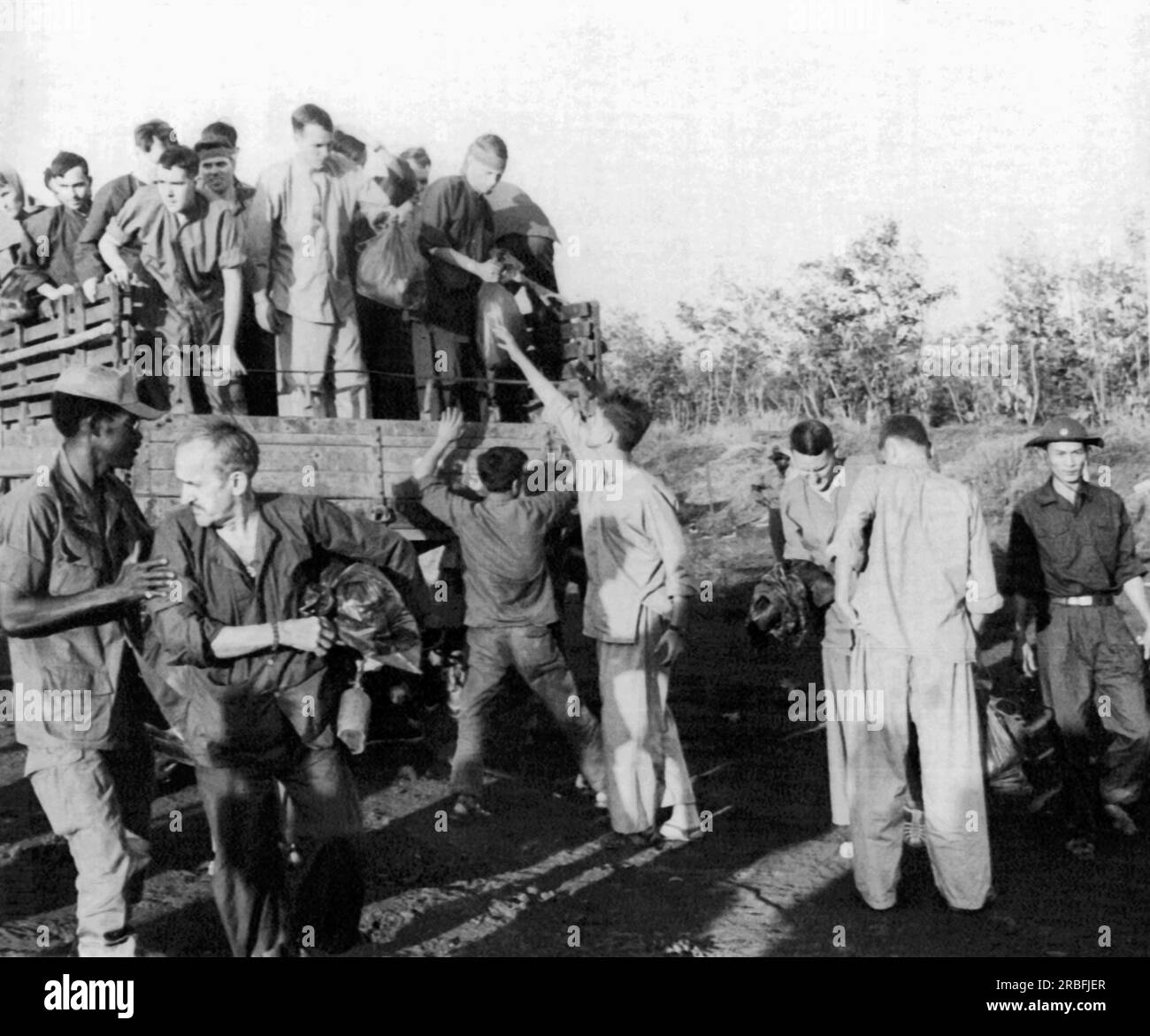 Vietnam:   February 13, 1973 American POWs alight from a truck somewhere in South Vietnam after their release by North Vietnam. Stock Photo