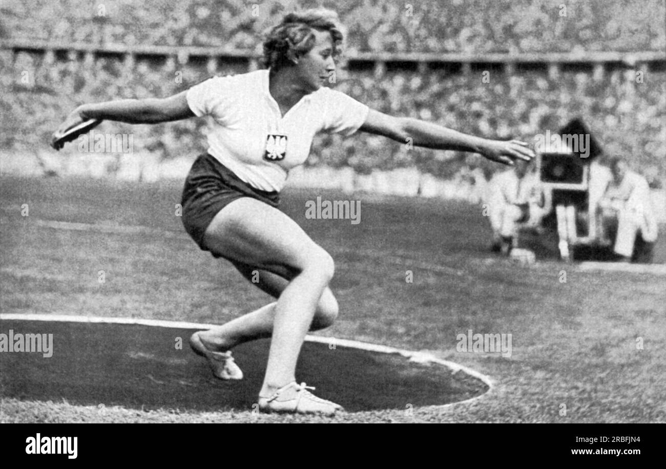 Berlin, Germany:  1936 Polish and Jewish athlete Hedwiga Wajsowna throwing the discus at the 1936 Olympics. She won the silver medal in the event. Stock Photo
